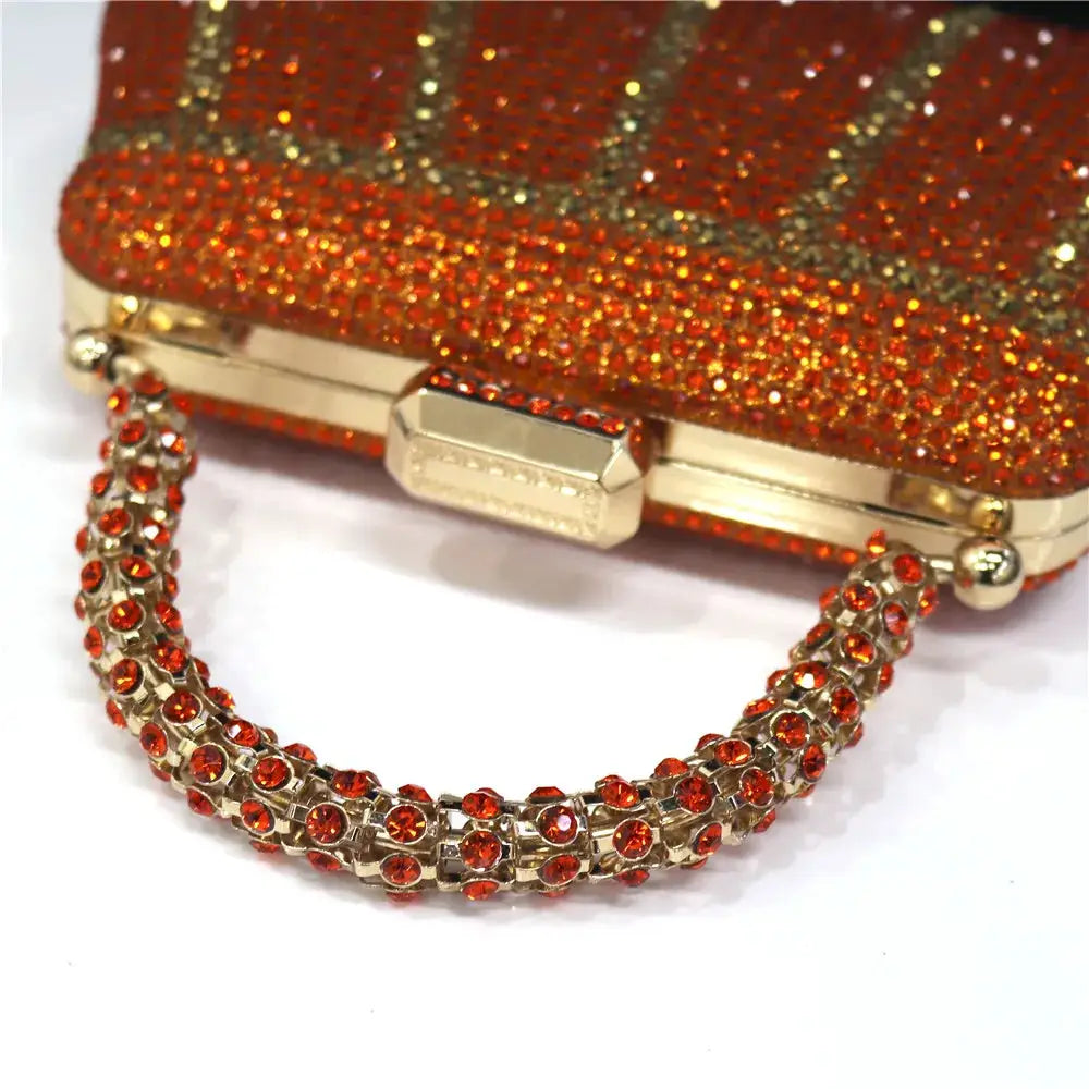 Simples Market red rhinestone evening clutch with gold-tone frame and jeweled chain handle.