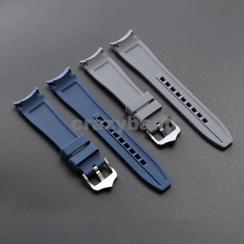Four 20/22mm silicone watch bands with curved ends in blue, navy and gray, each with a metal buckle.