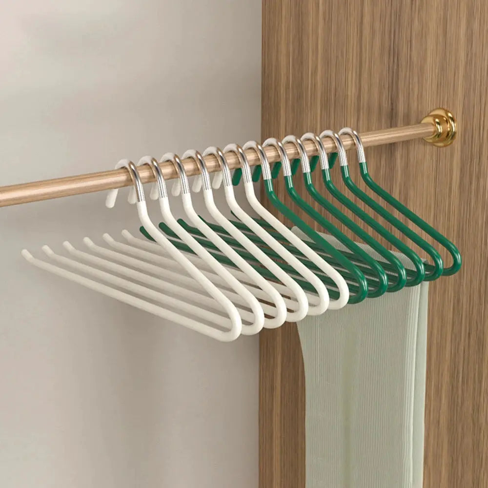 Goose-shaped pants hangers, anti-slip white and green, 30-pack on a copper closet rod