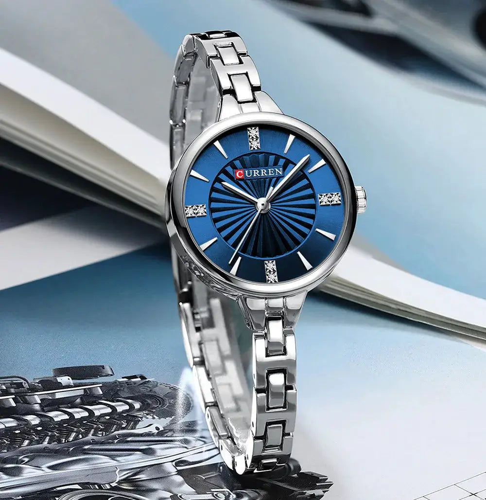 CURREN women's quartz watch with blue dial, silver stainless steel bracelet, crystal markers