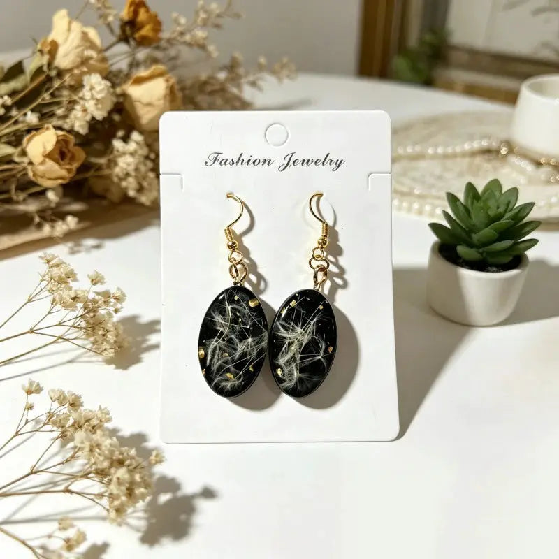 Unique design pressed flower earrings in black epoxy resin with gold hooks