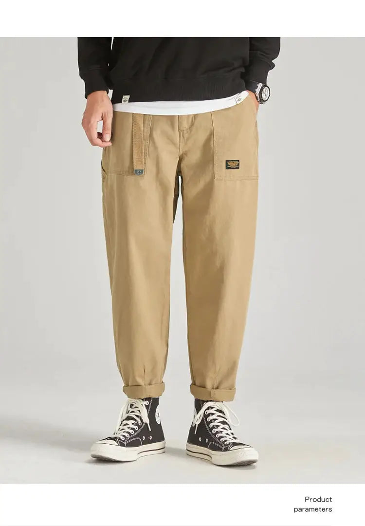 Men's khaki cargo pants with multiple pockets, belt-loop strap detail, and cuffed hems