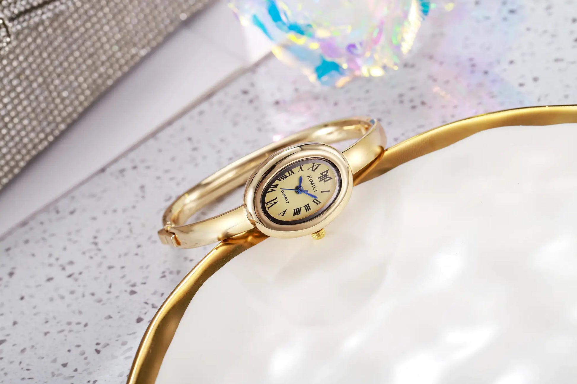 Gold-tone women's quartz wristwatch with Roman numeral dial and bracelet band