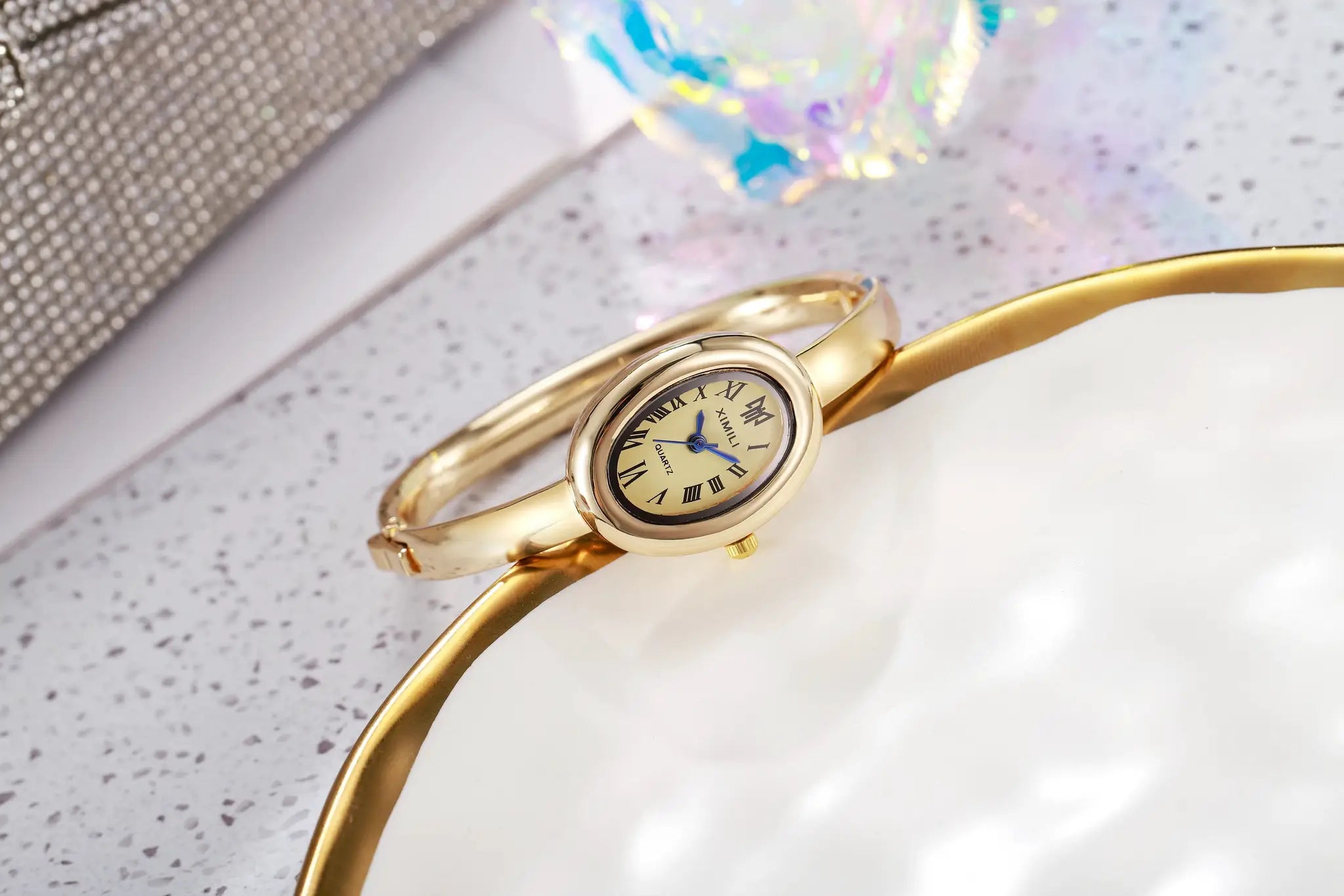 Gold-tone women's quartz wristwatch with Roman numeral dial and bracelet band