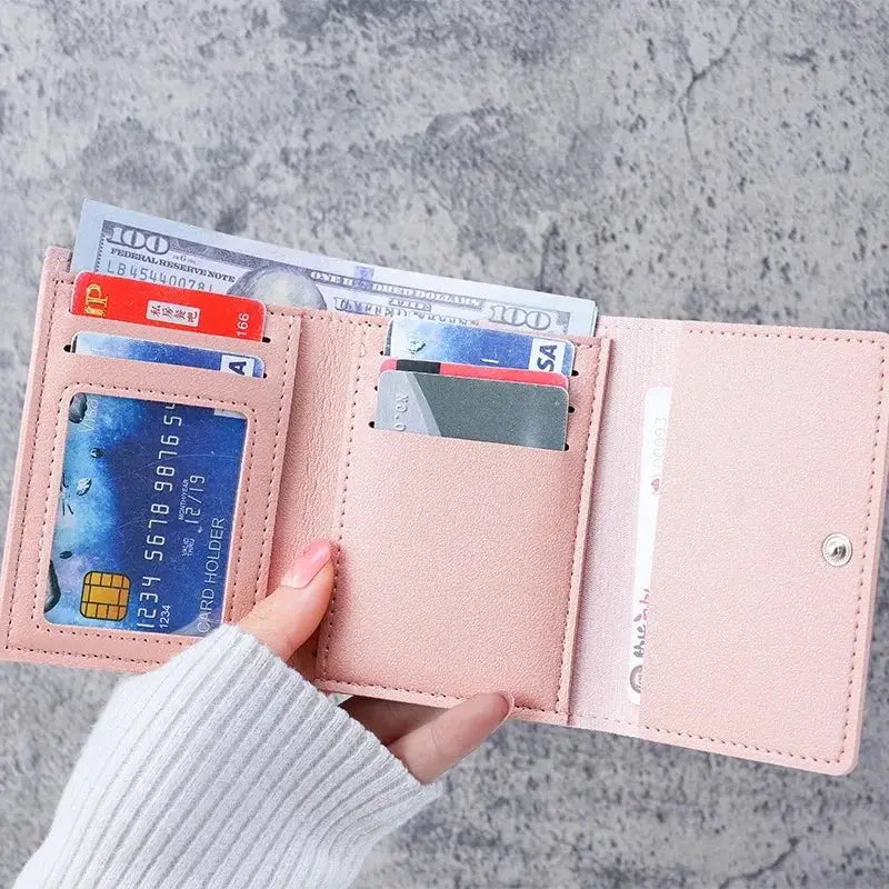 Pink Simples Market wallet with card slots and coin purse, open to reveal cash and cards