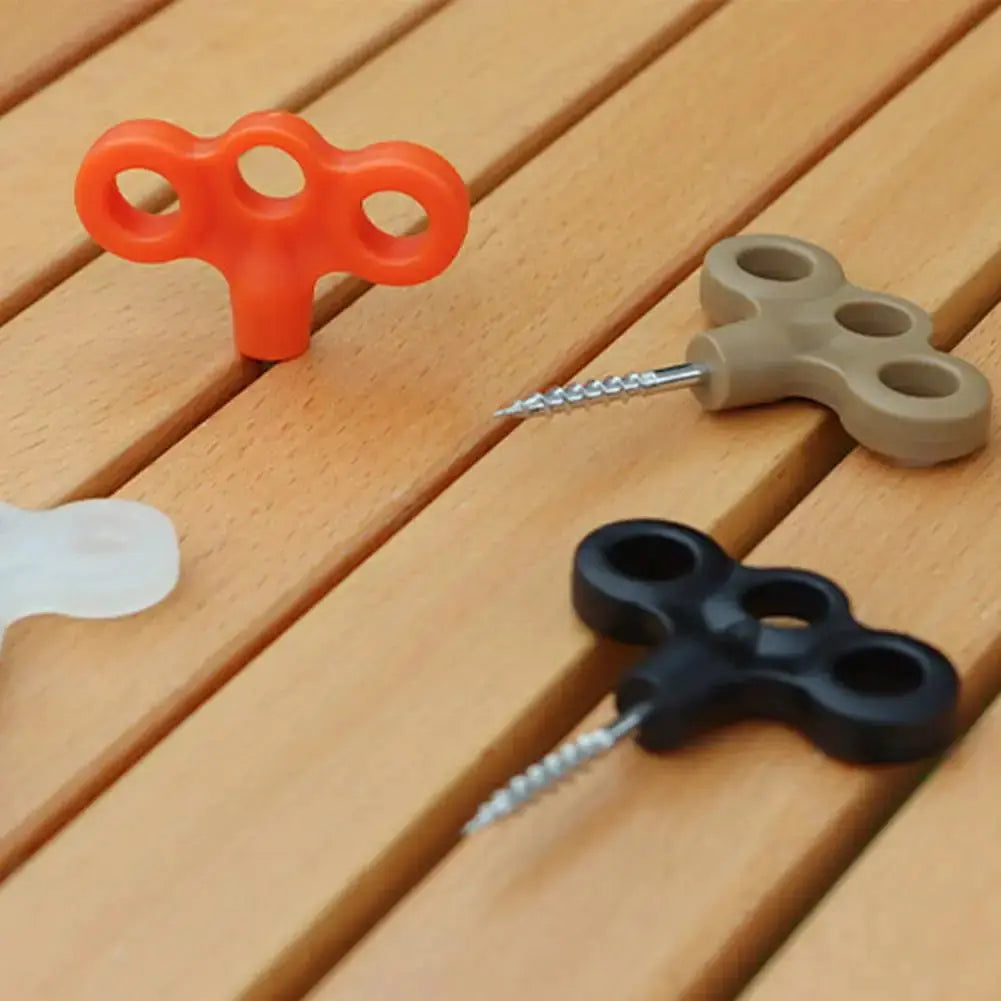 Ground anchors by Simples Market; three color variants (orange, beige, black) with stainless-steel screws.