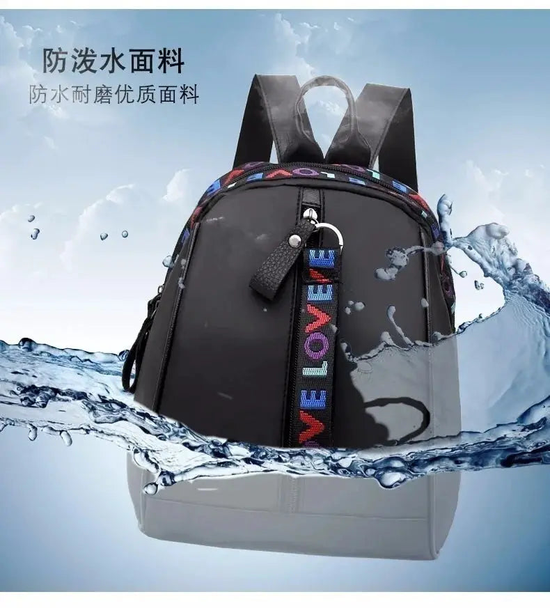 Women's backpack by Simples Market, black water-repellent fabric casual shoulder bag with multicolor LOVE strap.