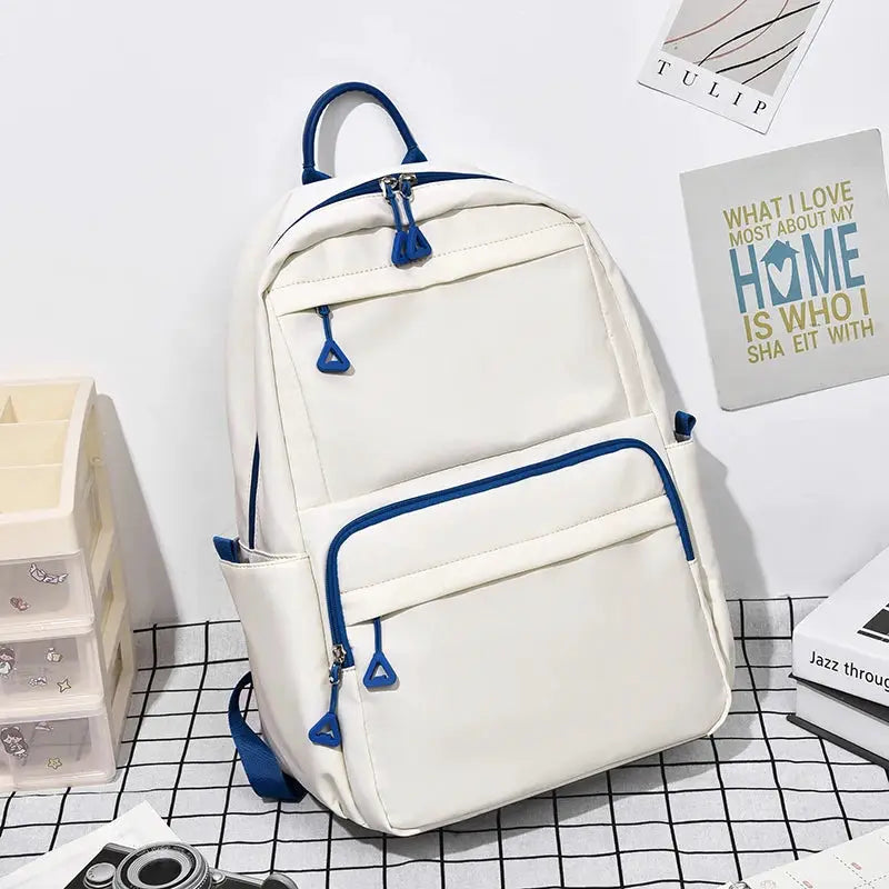 Backpack by Simples Market, white with blue zippers and trim, large-capacity casual student laptop backpack.