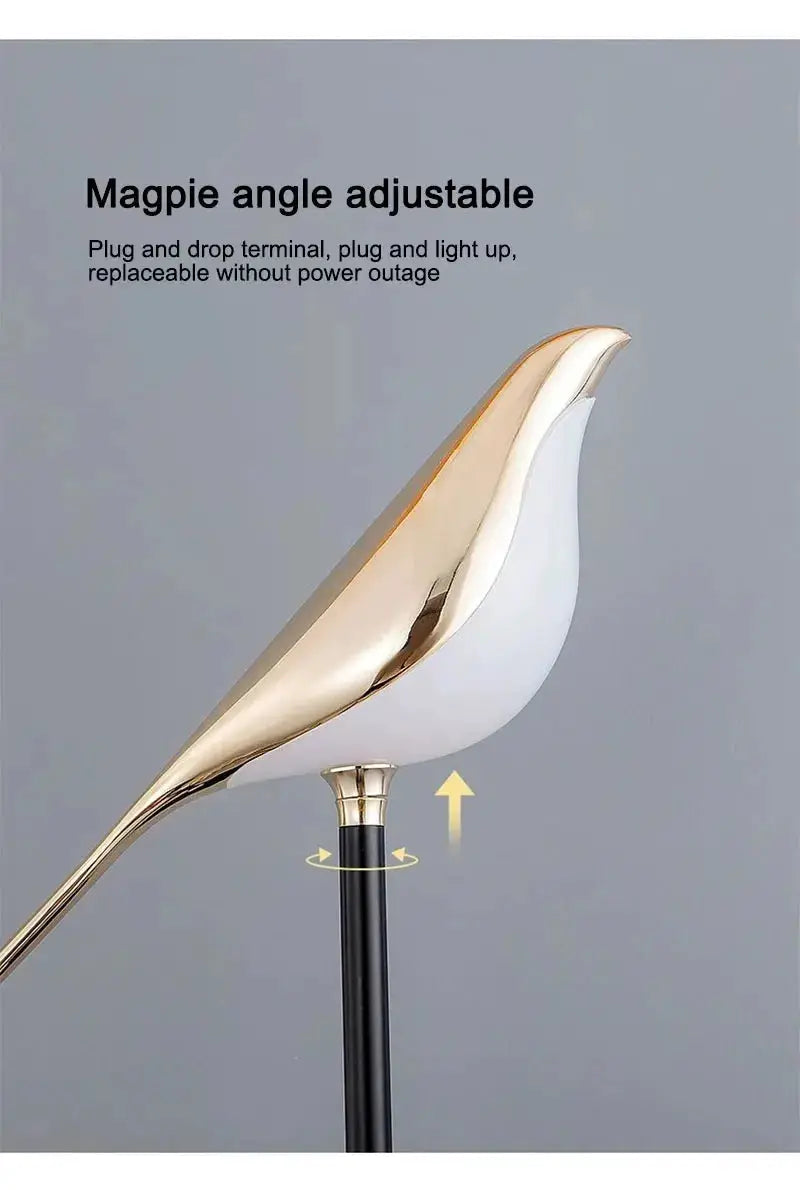 Magpie LED wall lamp by Simples Market; gold-and-white bird sculpture with adjustable angle on black stand