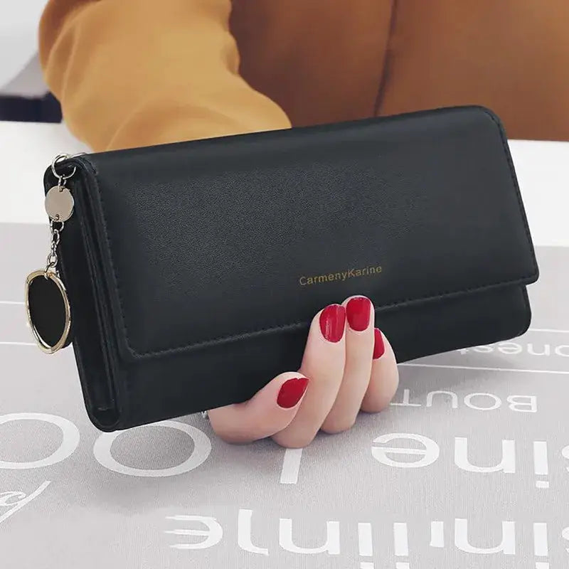 Black PU leather long wallet with fold design, gold brand logo, and attached gold key ring charm
