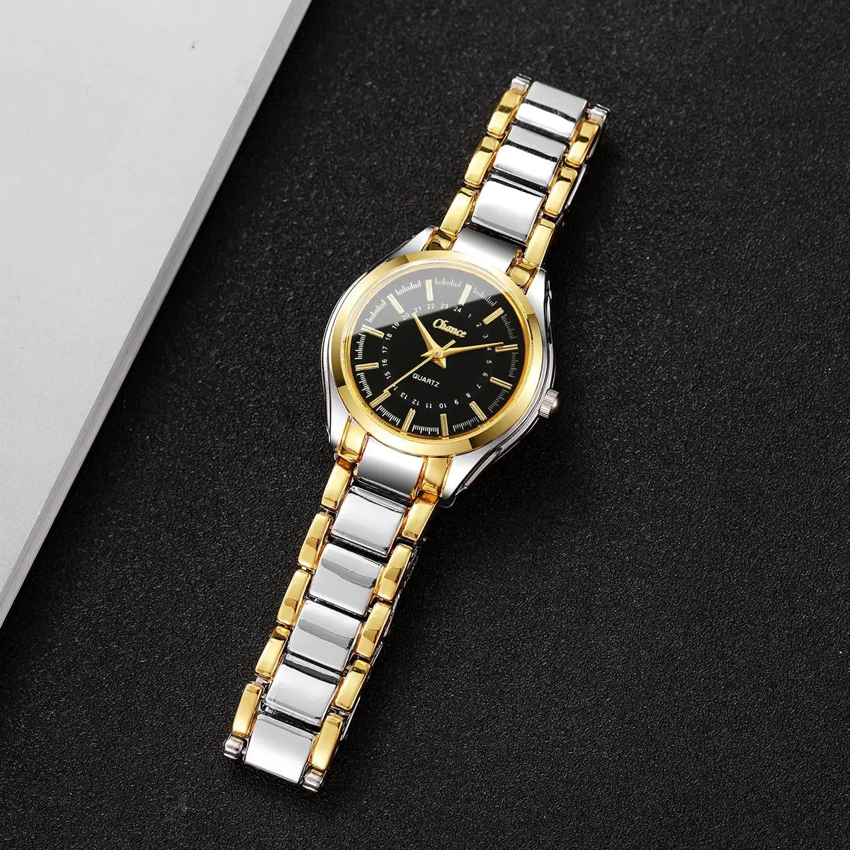 Women's two-tone gold and silver bracelet watch with black dial and analog quartz movement