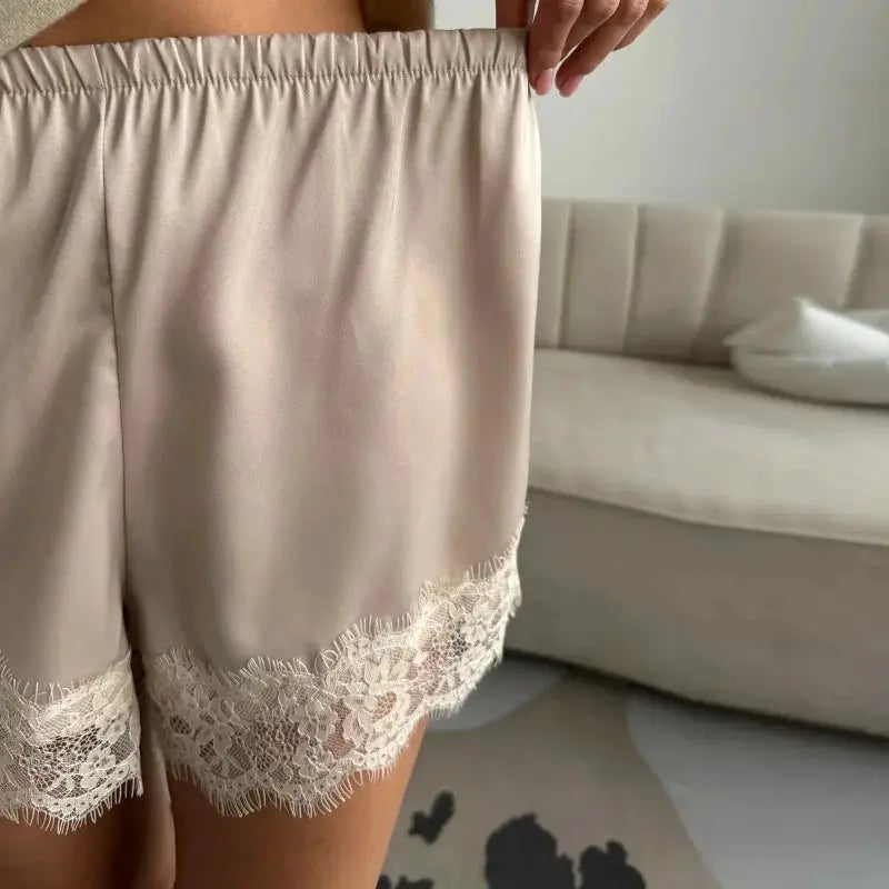 Satin shorts in beige with lace hem and elastic waistband
