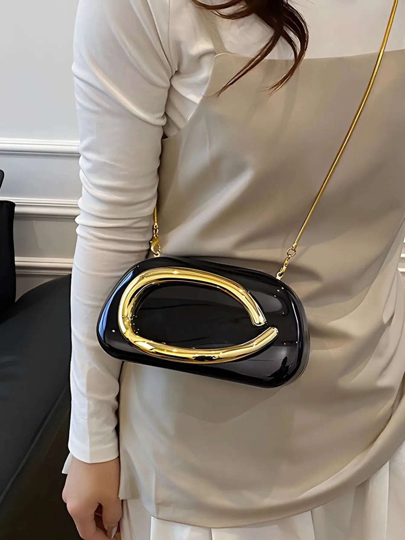 Simples Market acrylic box crossbody bag, black with a gold-tone curved handle and gold chain strap