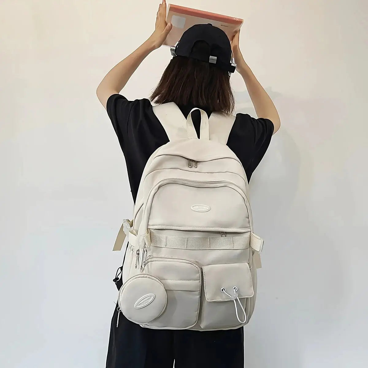 Simple Large Capacity Sports Travel Backpack by Simples Market in cream with multiple pockets and round pouch