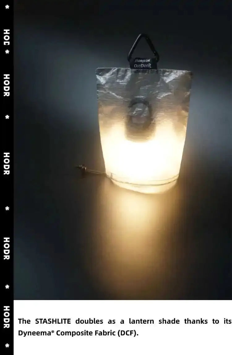 STASHLITE Dyneema DCF lantern diffuser stuff sack with carabiner, glowing light inside