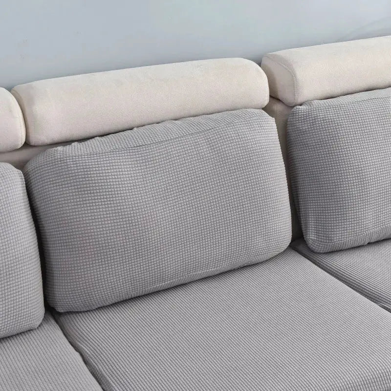Thick elastic sofa cover by Simples Market in solid light gray fabric for living room