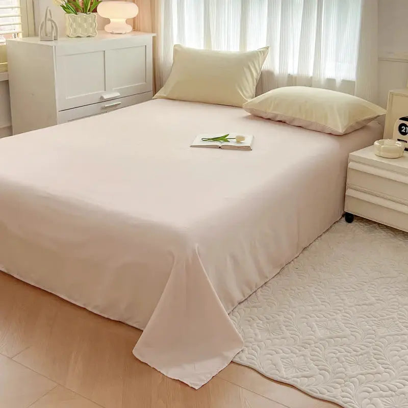 4-piece 2-side solid color brush fabric bed set with duvet cover, pillowcases, bed sheet and quilt cover on a white bed