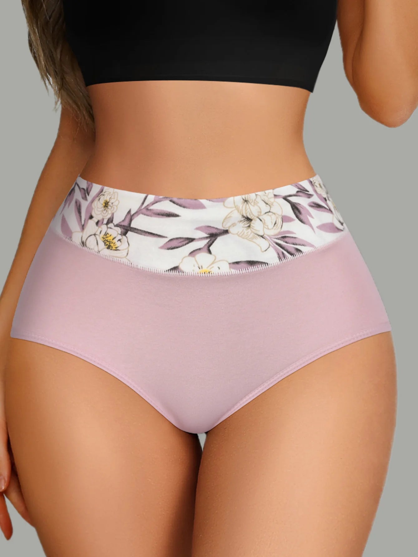 Women's high-waist cotton briefs in pale pink with floral waistband, back view.