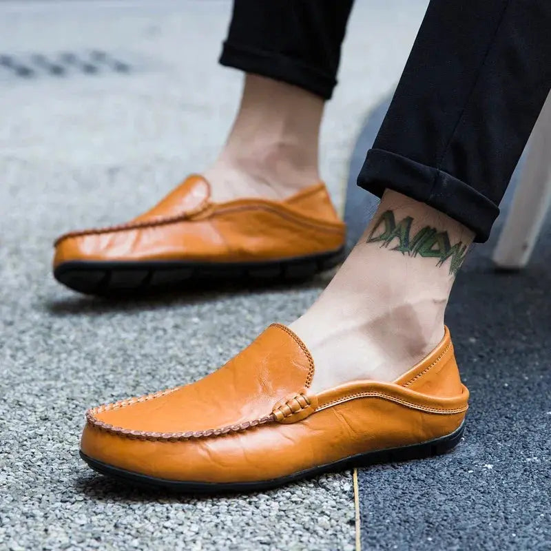 Tan genuine leather men's loafers, slip-on moccasin-style pair with visible stitching