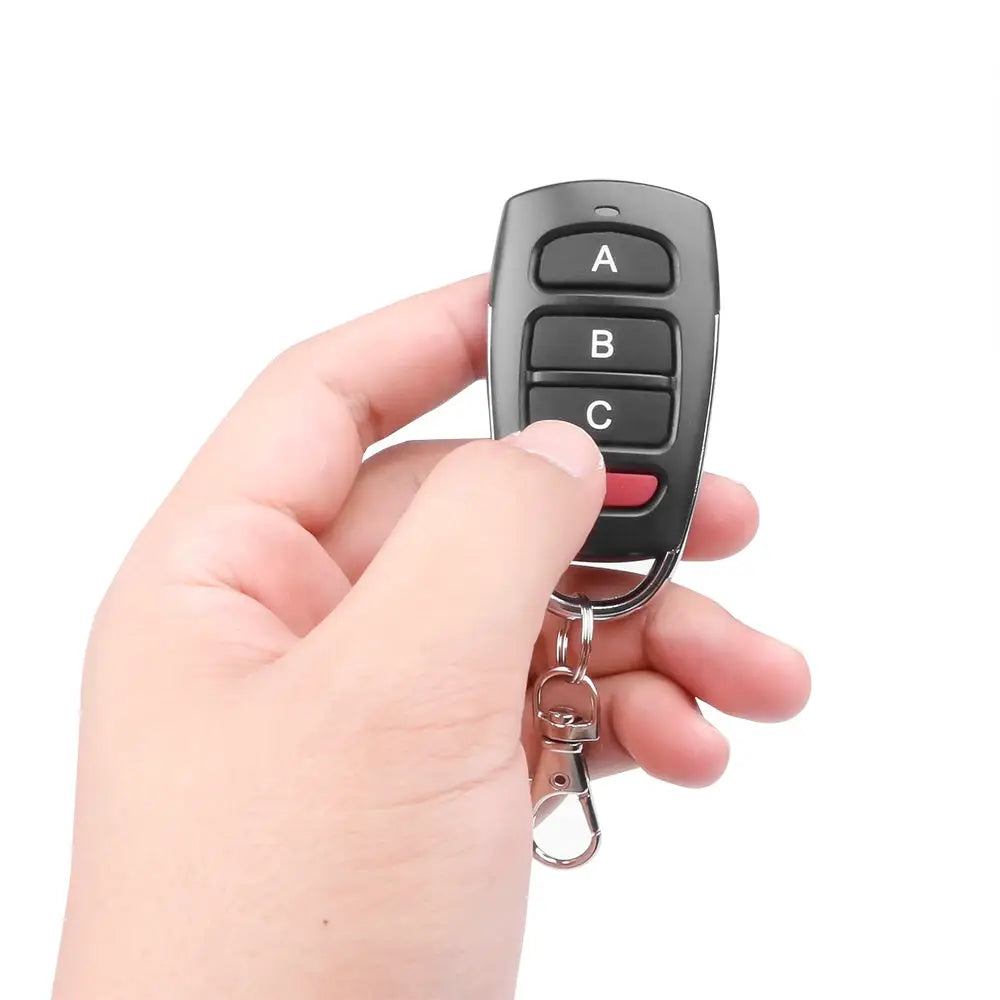 Simples Market wireless RF 433MHz remote key fob with A B C buttons and red bottom button on a keyring