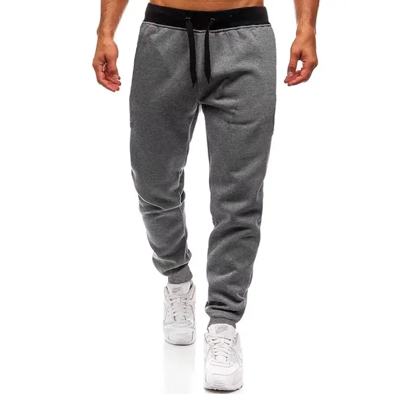 Men's grey jogger pants with black waistband and drawstring, casual sportswear