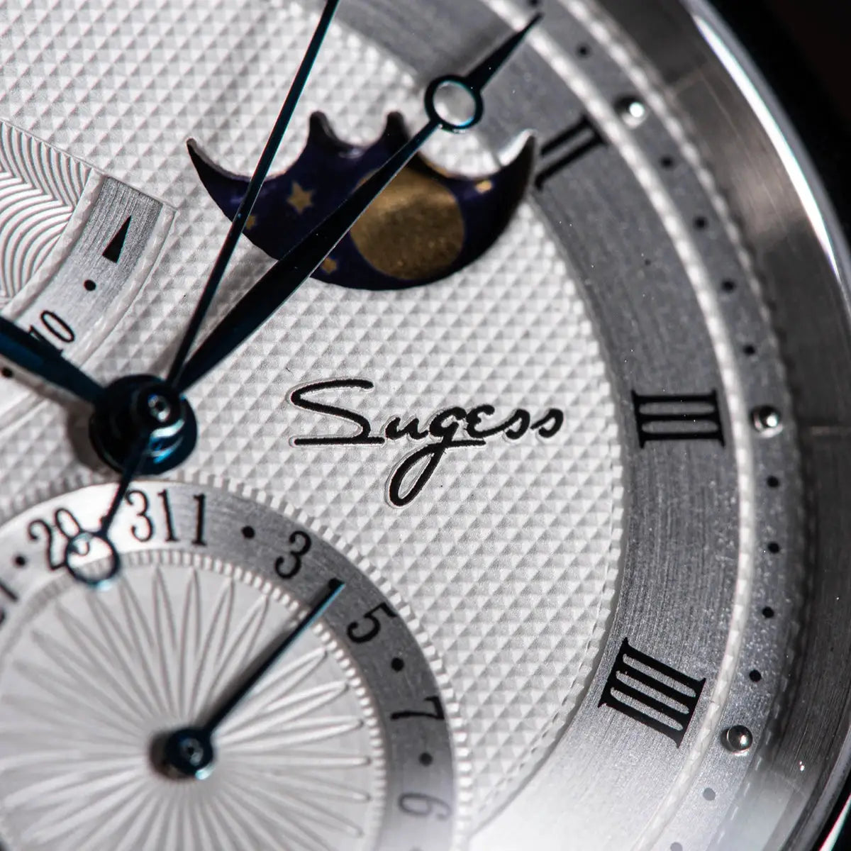 Sugess Moonphase wristwatch; textured silver dial with blue hands and moonphase indicator.