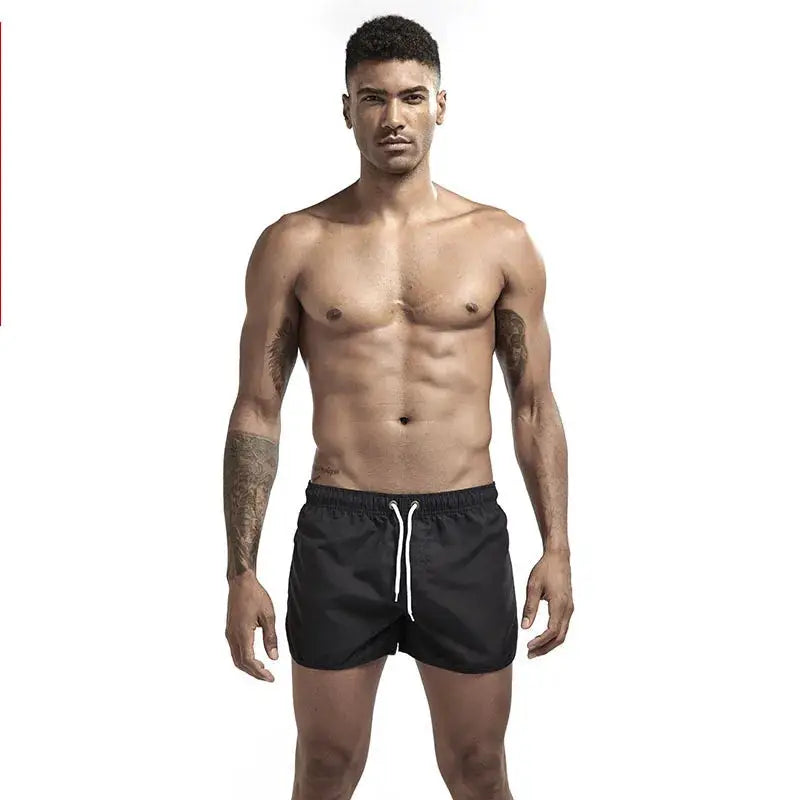 Men's black swim shorts with white drawstring, board-short style