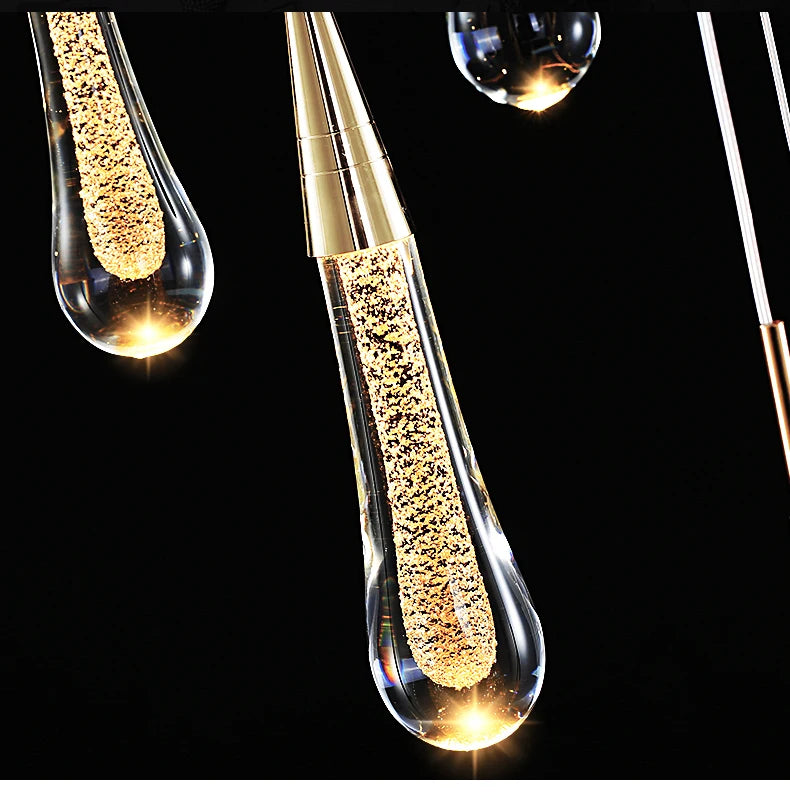 Crystal LED pendant lights with teardrop glass drops and gold glitter inside.