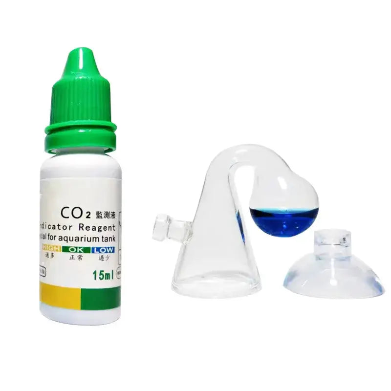 CO2 indicator solution bottle for aquarium with green cap beside glass drop-checker showing blue liquid