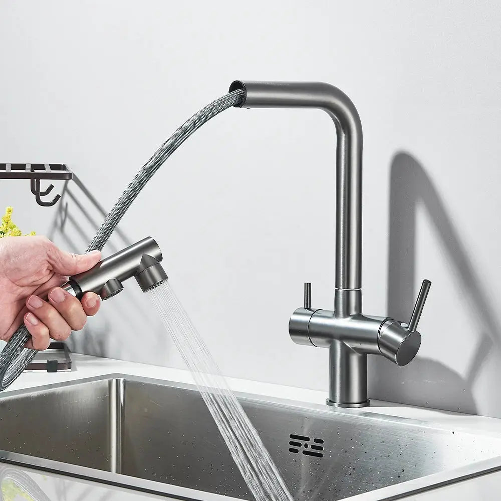 Kitchen pull-out faucet in dark metal finish with braided hose and dual-lever mixer at sink