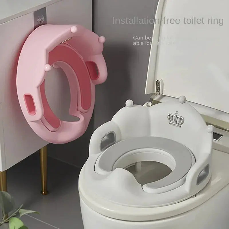 Simples Market baby and child toilet seat ring in pink, paired with a white toddler toilet seat