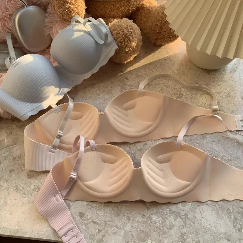 Push-up seamless bras by Simples Market; beige and white ribbed non-wire bralettes with adjustable straps (set of four).