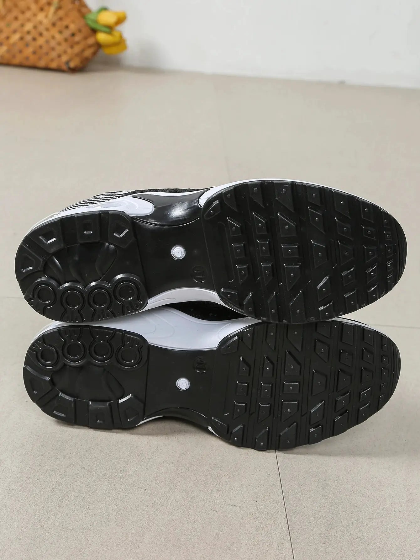 Pair of men's running shoes outsole; black rubber tread with square lugs, Simples Market