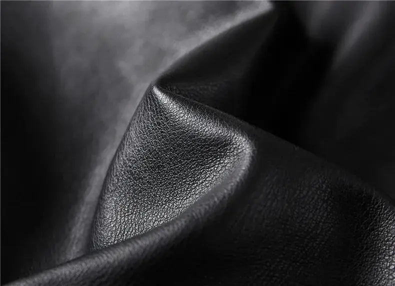 Men's black leather motorcycle jacket by Simples Market, textured leather close-up