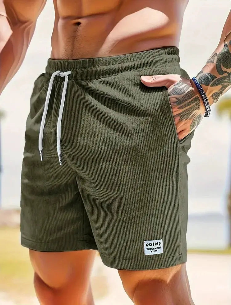 Men's olive-green corduroy shorts with white drawstring, loose fit, and pockets
