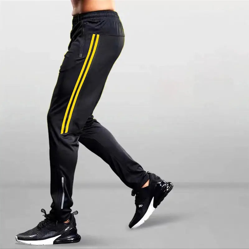 Men's black jogging pants with yellow side stripes and elastic waist