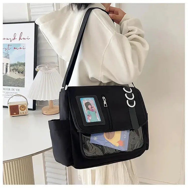 Black ita bag with transparent front window, crossbody strap and card display panels