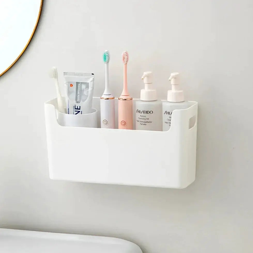 White wall-mounted bathroom organizer with toothbrushes, toothpaste, and SHISEIDO bottles