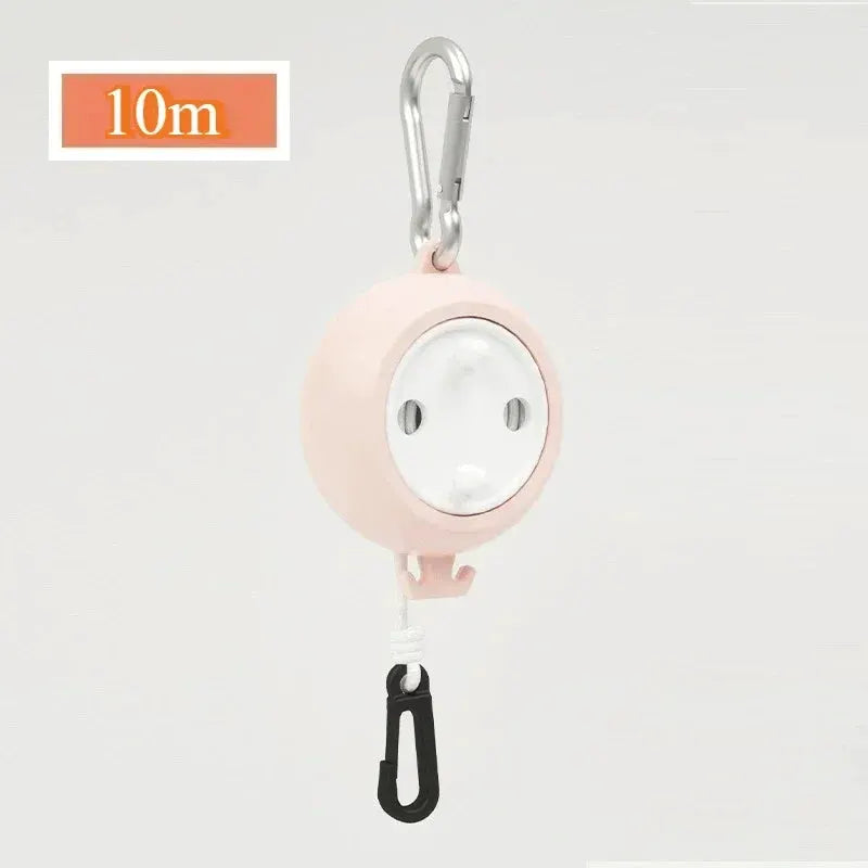 Retractable clothesline with pink housing, 10m windproof cord, Simples Market brand, includes carabiner.