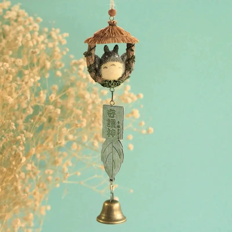 Resin wind chime ornament for outdoor hanging, featuring a tiny animal in a thatched gazebo, with a leaf plaque and bell