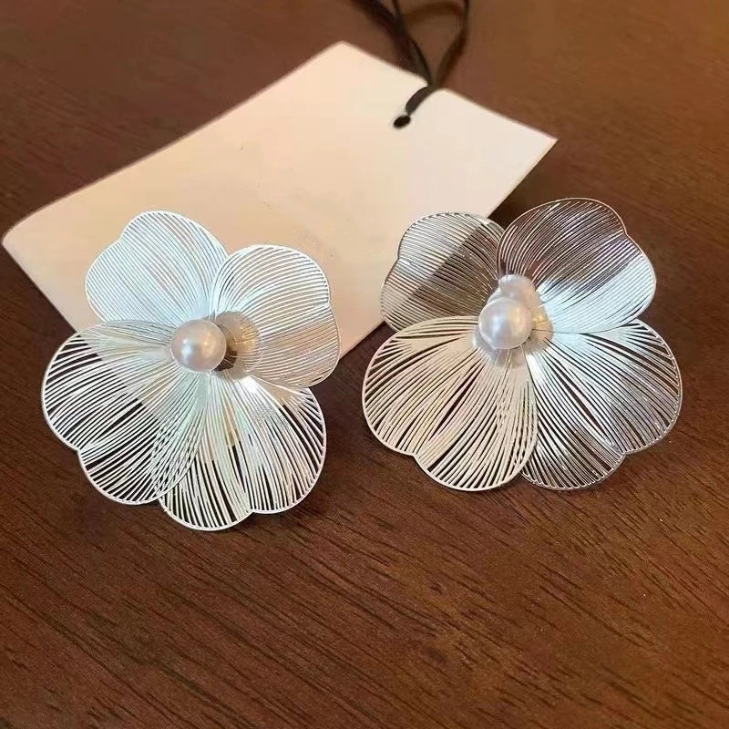 Pair of large flower pearl earrings with silver-tone petals and central pearls