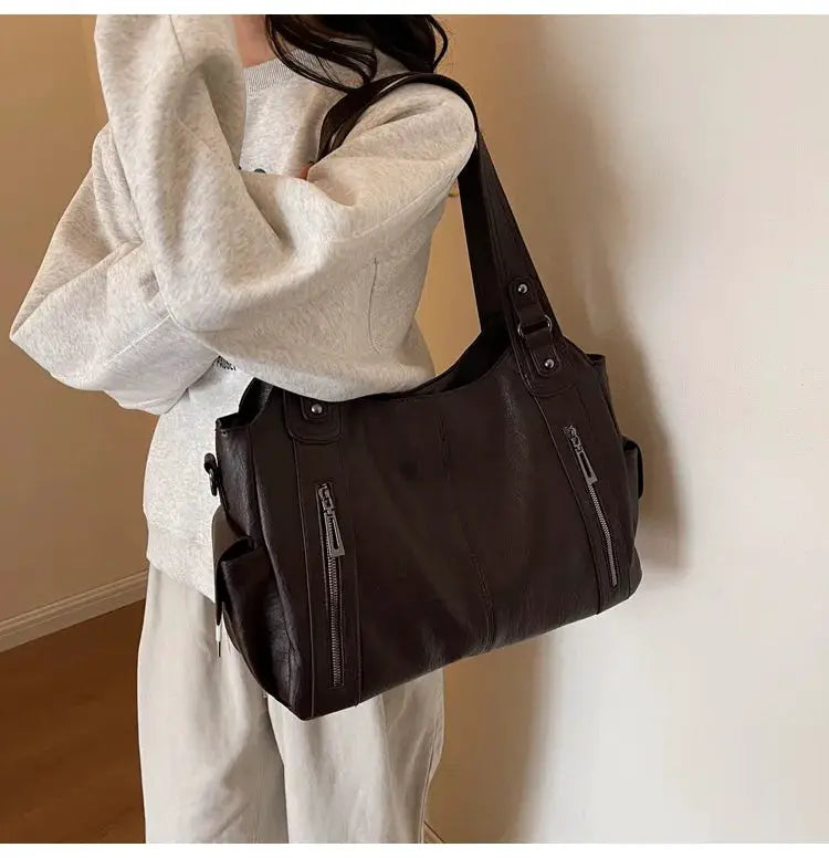 Soft interior compartment shoulder bag by Simples Market in dark brown PU leather with dual front zippers
