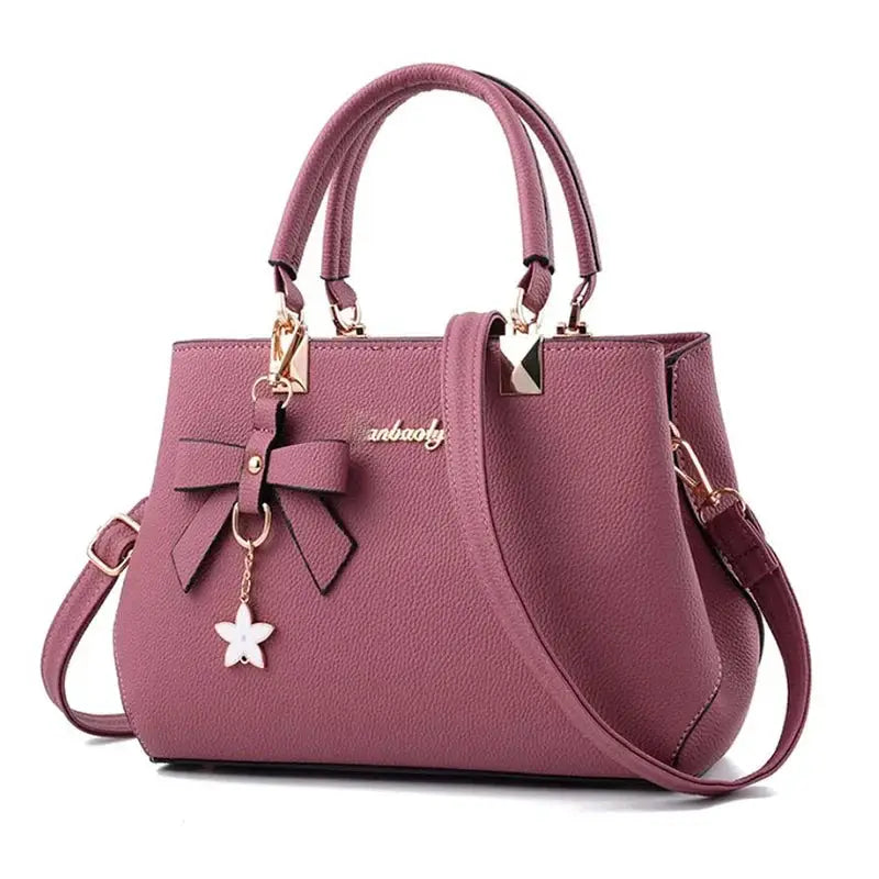 Simples Market plum shoulder bag with bowknot charm, pebbled leather, dual top handles and detachable crossbody strap