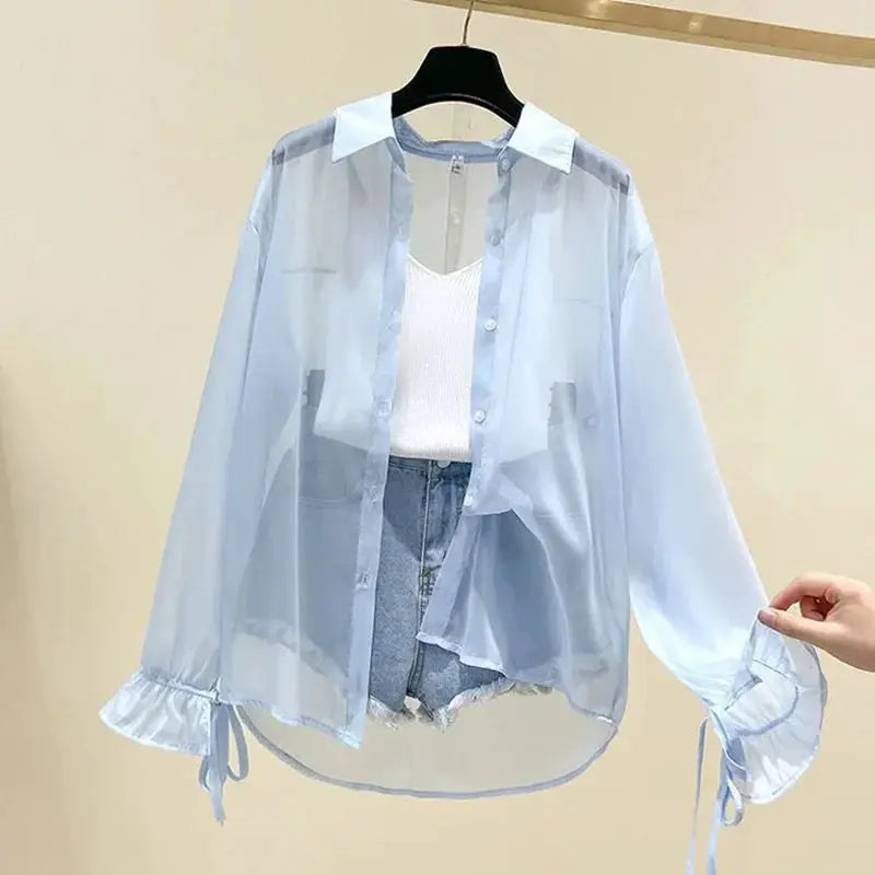 Chiffon blouse by Simples Market Smvp, light blue sheer long-sleeve button-up with bow-tied cuffs.