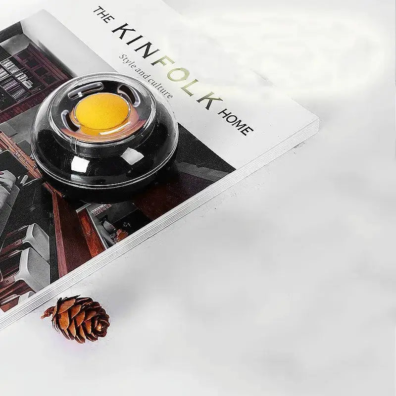 Round finger-wet money counting tool in a black plastic case with clear dome and yellow center.