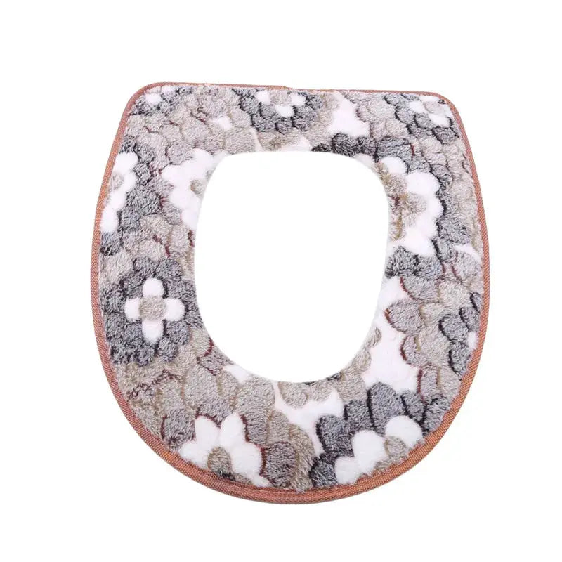 Simples Market plush toilet seat cover with fuzzy multicolor pattern and pink edge.
