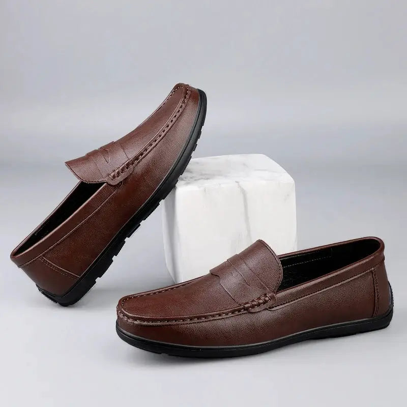 Pair of brown genuine leather men's loafers with black sole, slip-on dress shoes