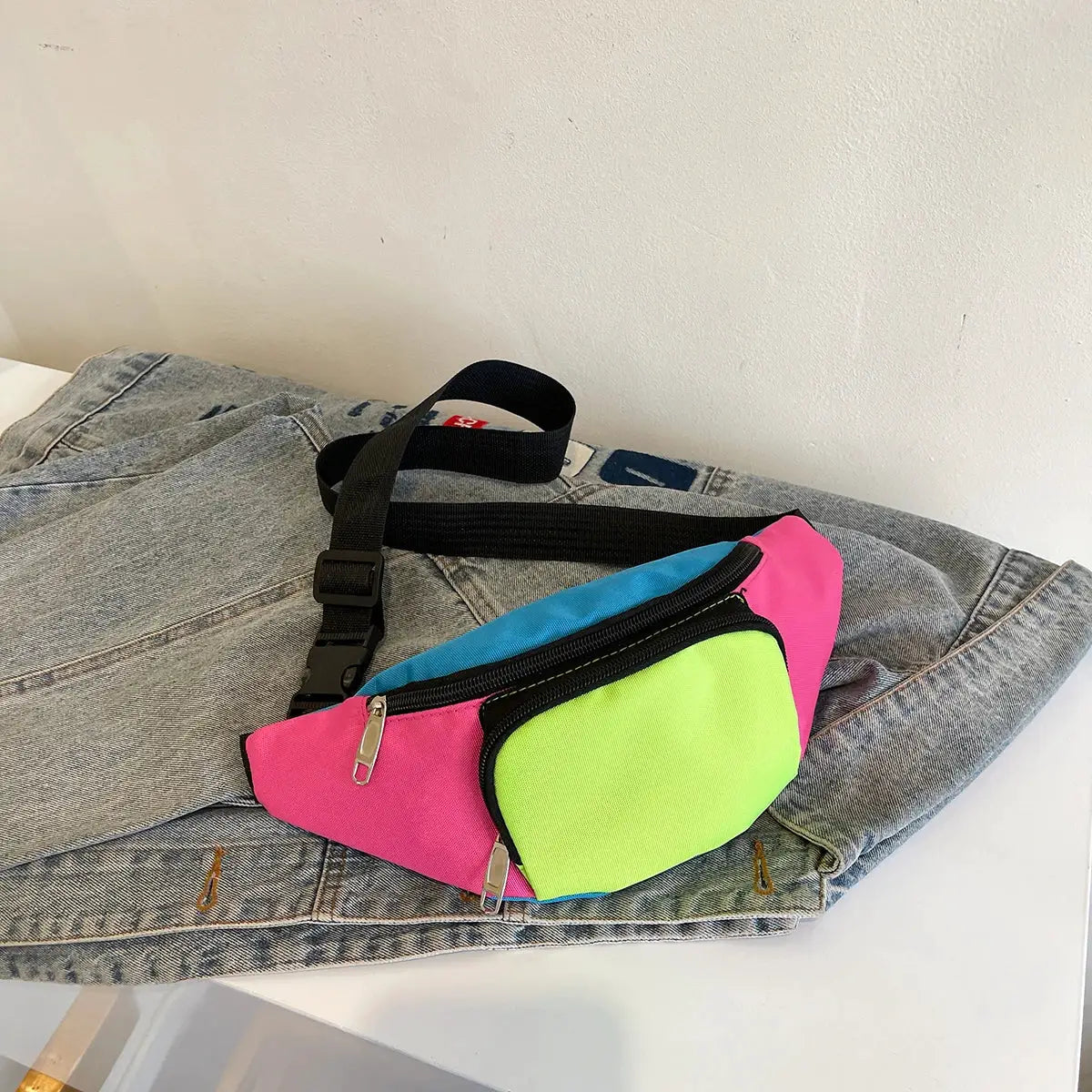 Fanny pack waist bag neon color-block design (pink, blue, lime) with black strap and silver zippers