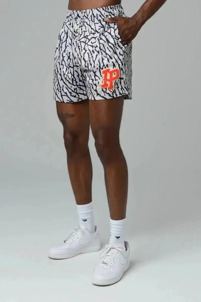 Mens shorts with black-and-white zebra print and orange logo on leg