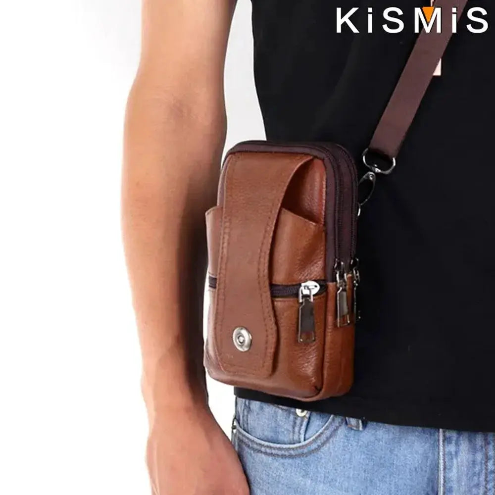 KISMIS men's brown leather waist bag with large capacity, multiple pockets, and adjustable shoulder strap.